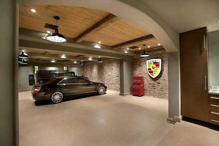 Near the master suite is a three-car display garage. This showroom includes pneumatic air hoses, epoxy flooring, and tool storage