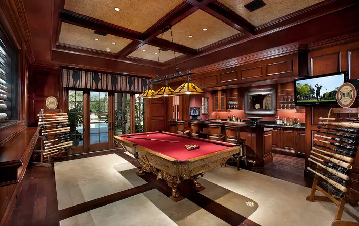 Farther down the hallway is a game room and adjoining Western-themed billiards parlor with a wet bar