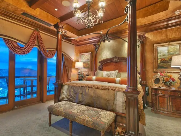 Here is the master bedroom with four-poster bed, porch, and chandelier