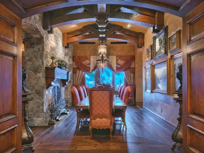 The separate dining room has a gorgeous stone fireplace and a table that can seat 10