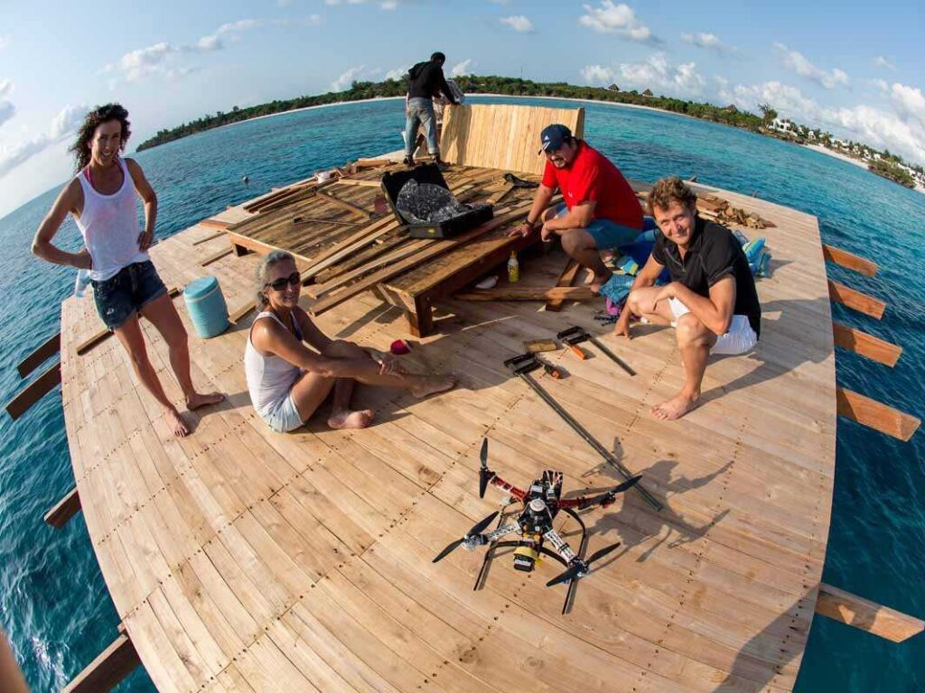 A small team helped Anhede strategize the photo shoot of  the underwater hotel room. Here they’re fixing a sun bed on the upper deck for  models to pose on.