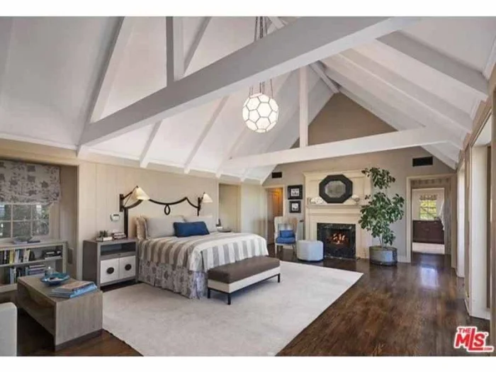 the-bedroom-features-a-dramatic-cathedral-ceiling